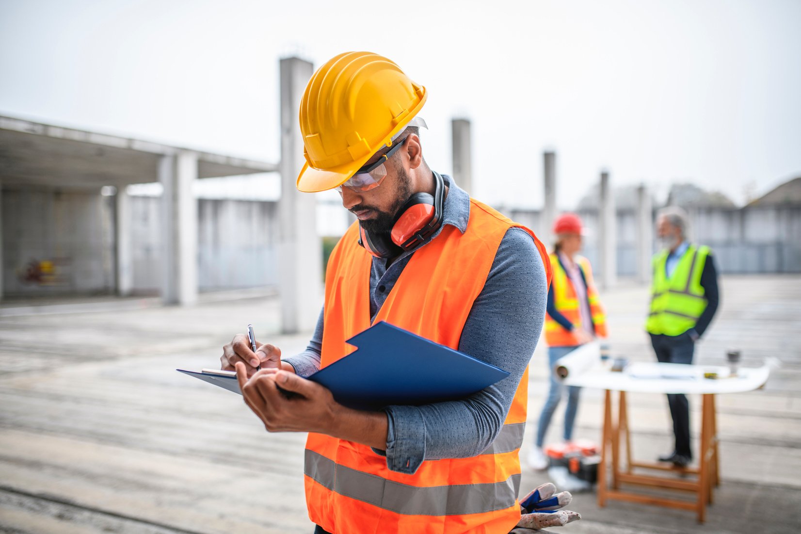 Construction Site Manager Making Notes